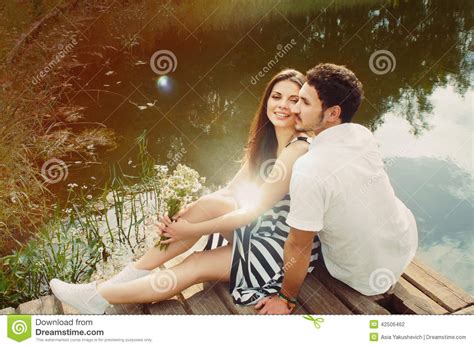 sensual romantic couple in love on pier at the lake in summer da stock
