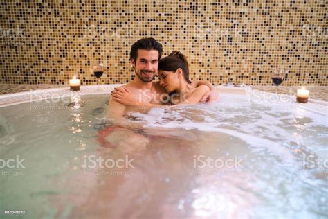 Romantic Couple Relaxing In Hot Tub At Health Spa Stock