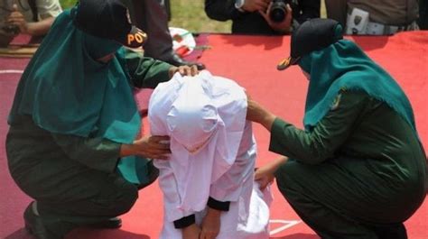 video shows elderly christian woman caned in indonesia for selling alcohol