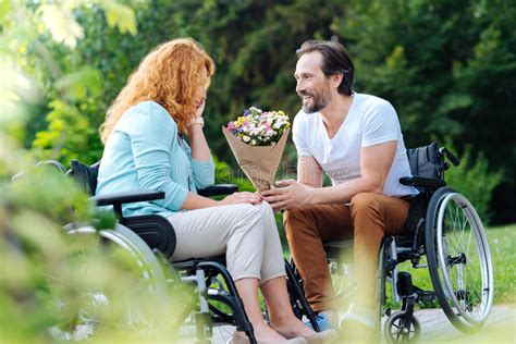 Man Presenting Flowers To His Girlfriend Stock Image