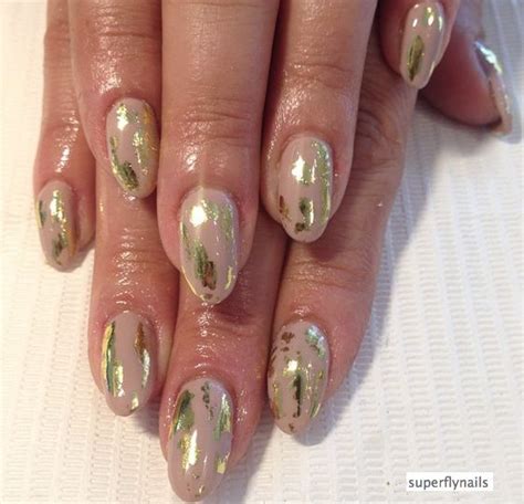 womans hand  gold  white manies   holding   nails
