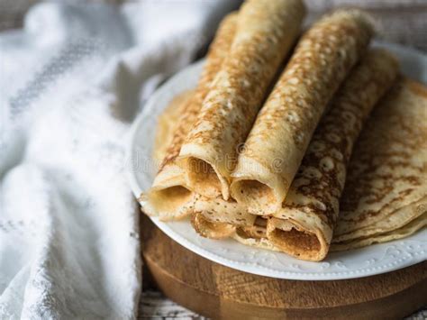 Russian Homemade Yeast Crepes Rolled Into A Tube On White