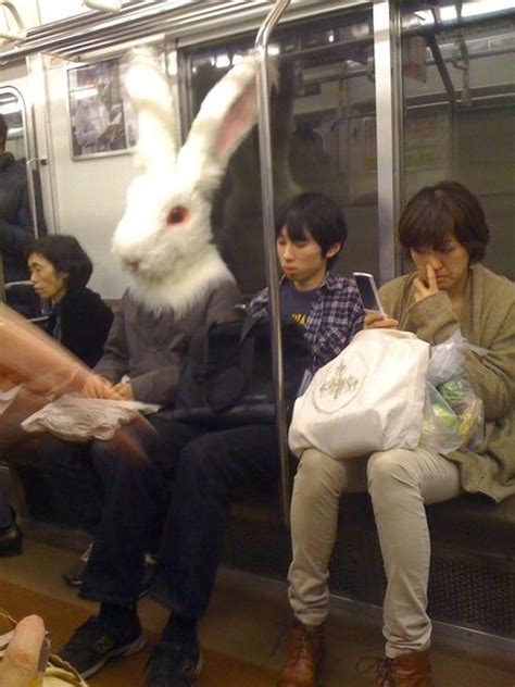 funny pictures with captions a man waring a huge bunny hat is sitting on the subway