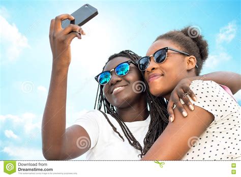 Two Diverse African Girls Taking Self Portrait With Phone