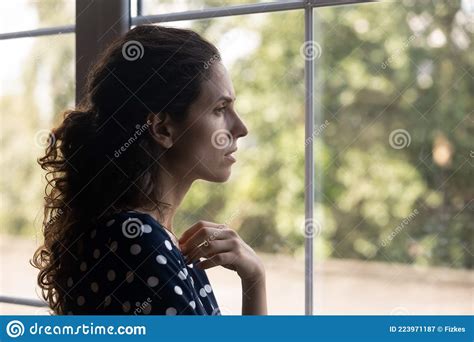 Frustrated Depressed Millennial Woman Looking Out Window Stock Image