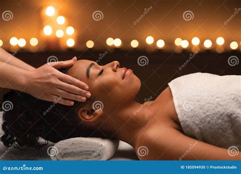 peaceful black woman  head massage  luxury spa stock photo