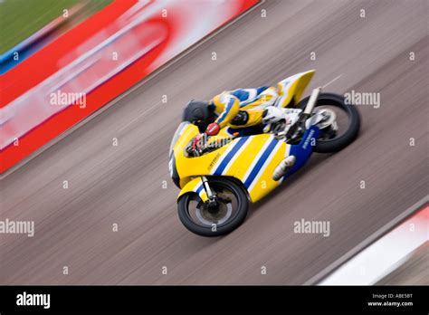 panned blur yellow racing  motorbike speed quick fast stock photo