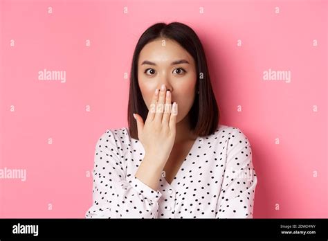 Image Of Shocked Asian Girl Gossiping Gasping And Cover Mouth Stare