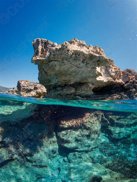 underwater   rock  emerges   turquoise stock photo