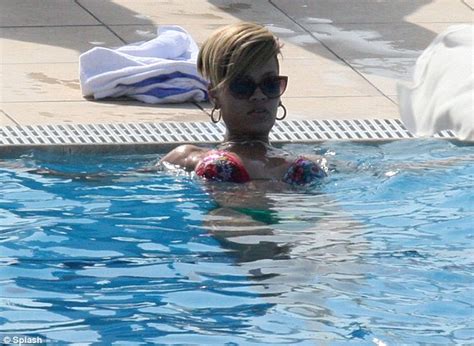 rihanna lounges around a pool in a string bikini as she takes time out