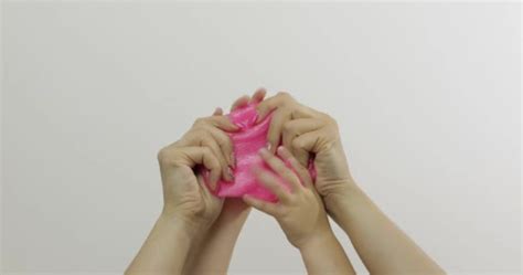Woman Is Stretching A Pink Slime And Playing Close Up