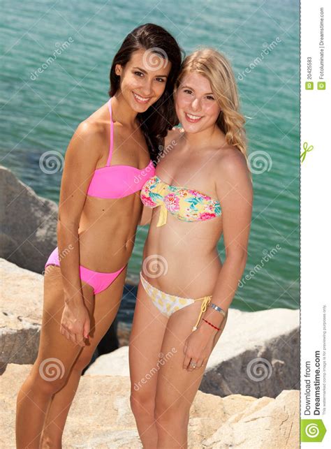 pretty blond and brunette girls at the beach stock image