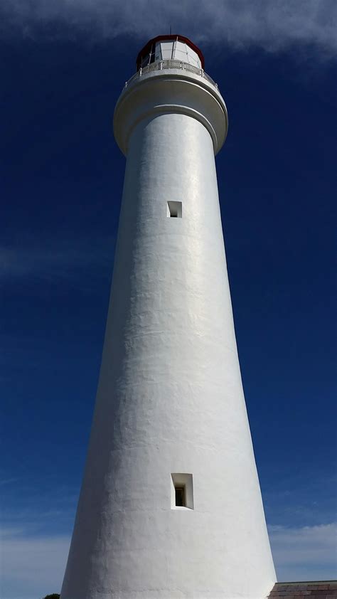 white lighthouse   angle photography  stock photo