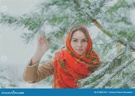 beautiful russian girl in the winter woods near a christmas tree stock