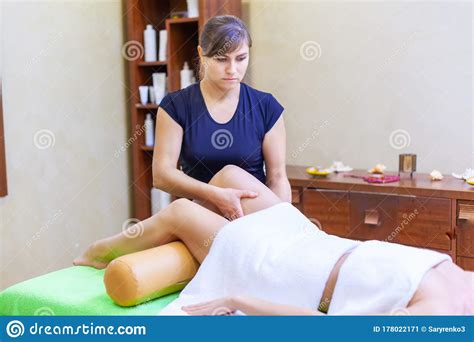 front view of professional massage therapist giving massage on woman