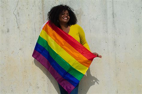 Very Happy Africanamerican Lesbian Woman With The Gay Pride Flag On Her