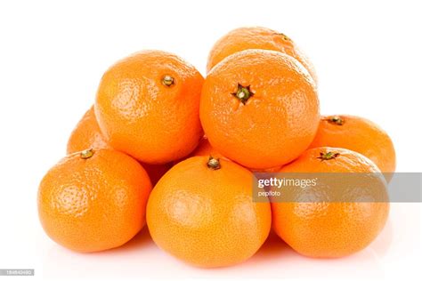 Pile Of Bright Fresh Tangerine Fruits On A White Background High Res