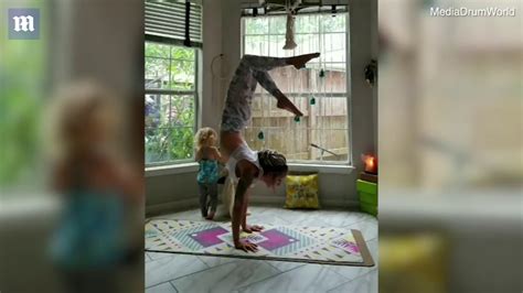 Mother Does Yoga Moves Whilst Breastfeeding Her Two Year Old Daily