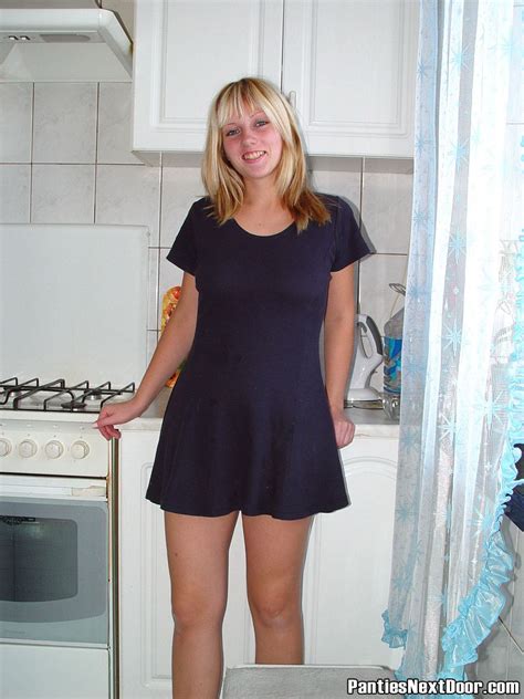take a look to this naughty blond amateur exploring off her red lacy panties in the kitchen