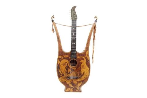 antique lyre guitar with engraved headstock panel and