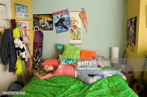 teenage girl lying on bed staring at ceiling elevated view