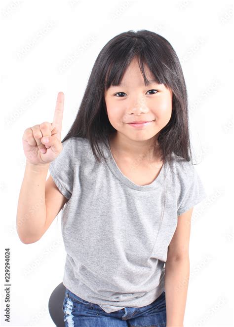 Portrait Of Little Cute Asian Girl With Her Finger Point Up Lovely