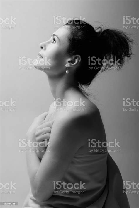 portrait of a mature brunette woman sitting and contemplates the
