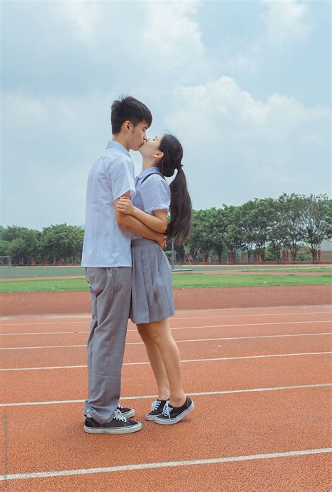 Young Asian College Couple Kissing By Stocksy Contributor Pansfun