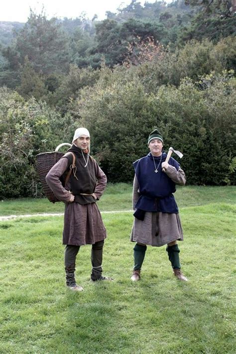 people dressed  medieval clothing standing  grass