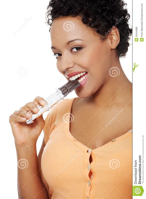 pregnant woman eating a chocolate royalty free stock