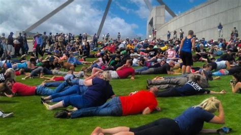 hundreds of people protest rolling down a hill is delightfully mesmerizing