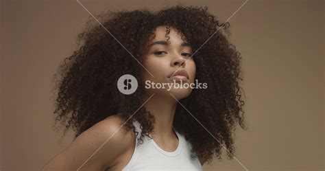 Mixed Race Black Woman Portrait With Big Afro Hair Curly Hair In Beige