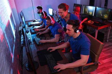 young people playing video games  computers esports tournament stock