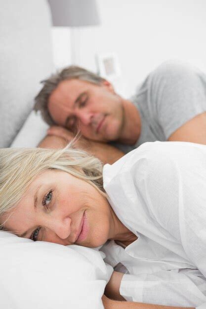 Premium Photo Woman Awake As Her Partner Is Sleeping In Bed