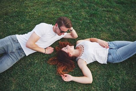 Free Photo A Romantic Couple Of Young People Lying On The Grass In