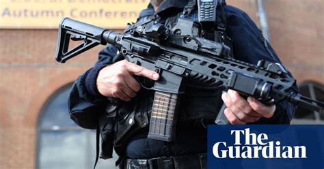 majority of police officers are prepared to carry guns survey finds