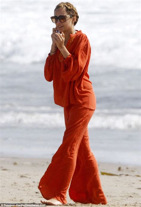 earth mother nicole richie wears a bright orange bohemian pantsuit as she and husband joel play