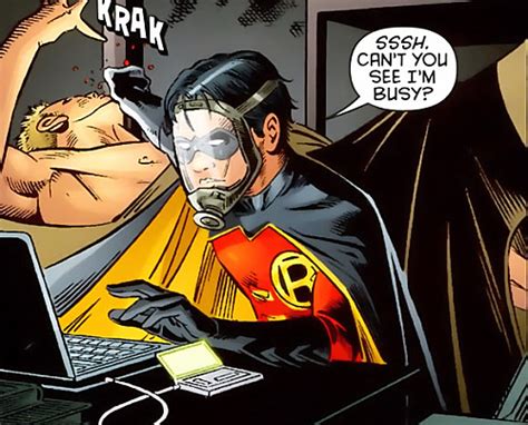 man   batman costume sitting   desk   laptop computer