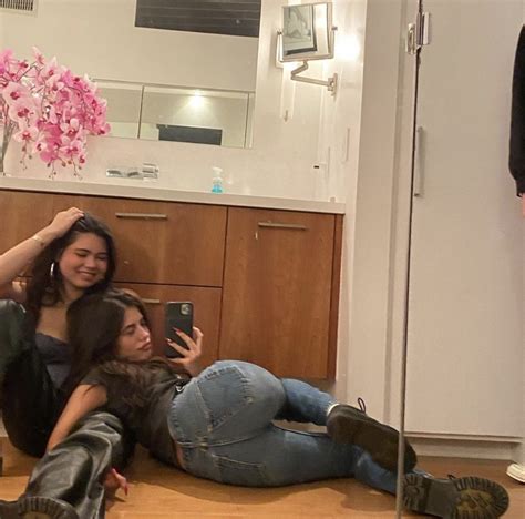 Two Women Are Taking A Selfie In The Bathroom While Another Woman Is On