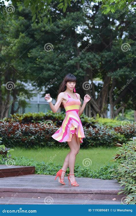 Beautiful And Sex Asian Girl Shows Her Youth In The Park Stock Image