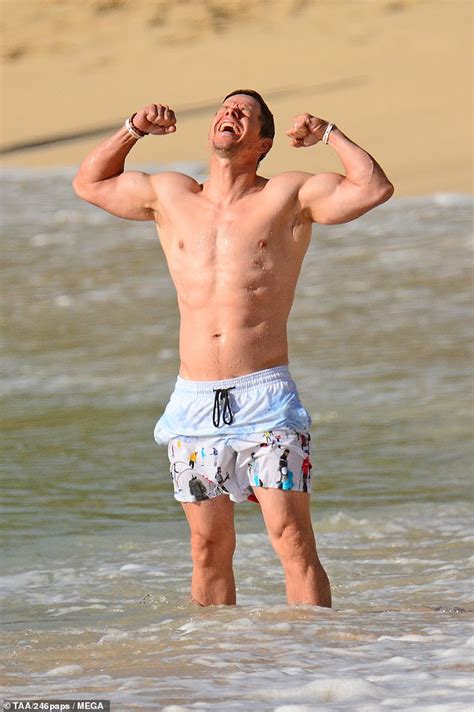 mark wahlberg shows off ripped abs as he takes bikini clad