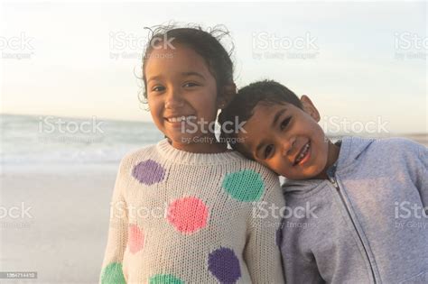Portrait Of Smiling Biracial Girl With Brother Leaning Head On Her