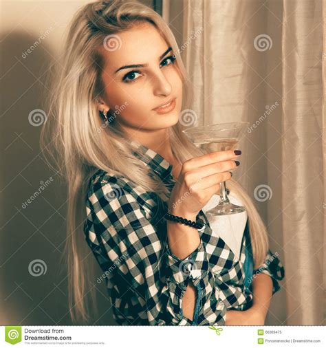 Beauty Blonde Lady With Glass Of Martini Looking At Camera Stock Image