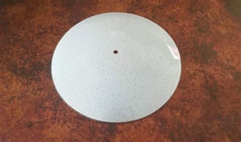 white plate sitting  top   brown table