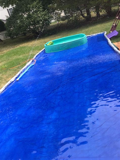 backyard splash pad one tarp with pool noodles rolled and