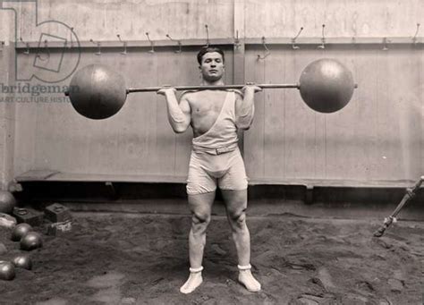 Portrait Of Olympic Gold Medalist Ernest Cadine Lifting Barbell Weights