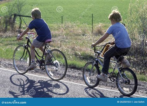 boys riding bicycles  rural road editorial stock photo image