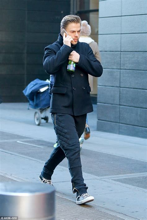 derek hough runs across the street while bundled up in black daily mail online
