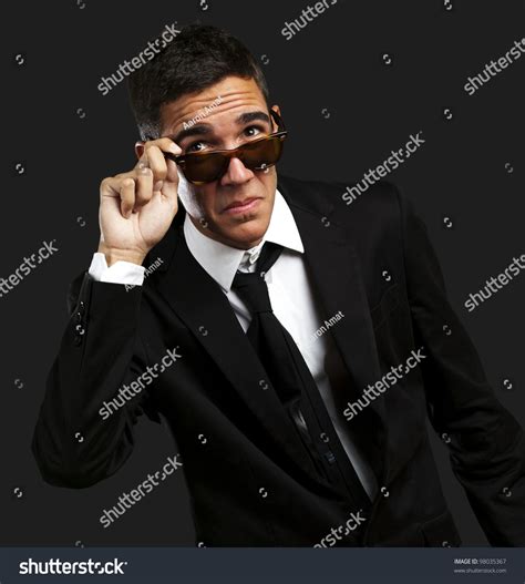 Portrait Of Business Man Taking Off The Sunglasses Against