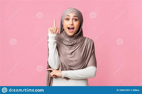 Excited Arabian Woman In Hijab Pointing Finger Up Having